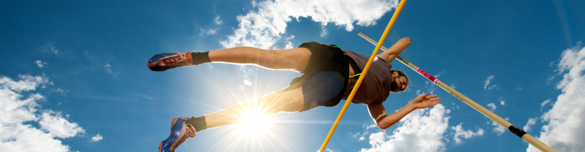 Below view of a young athlete at pole vault competition.