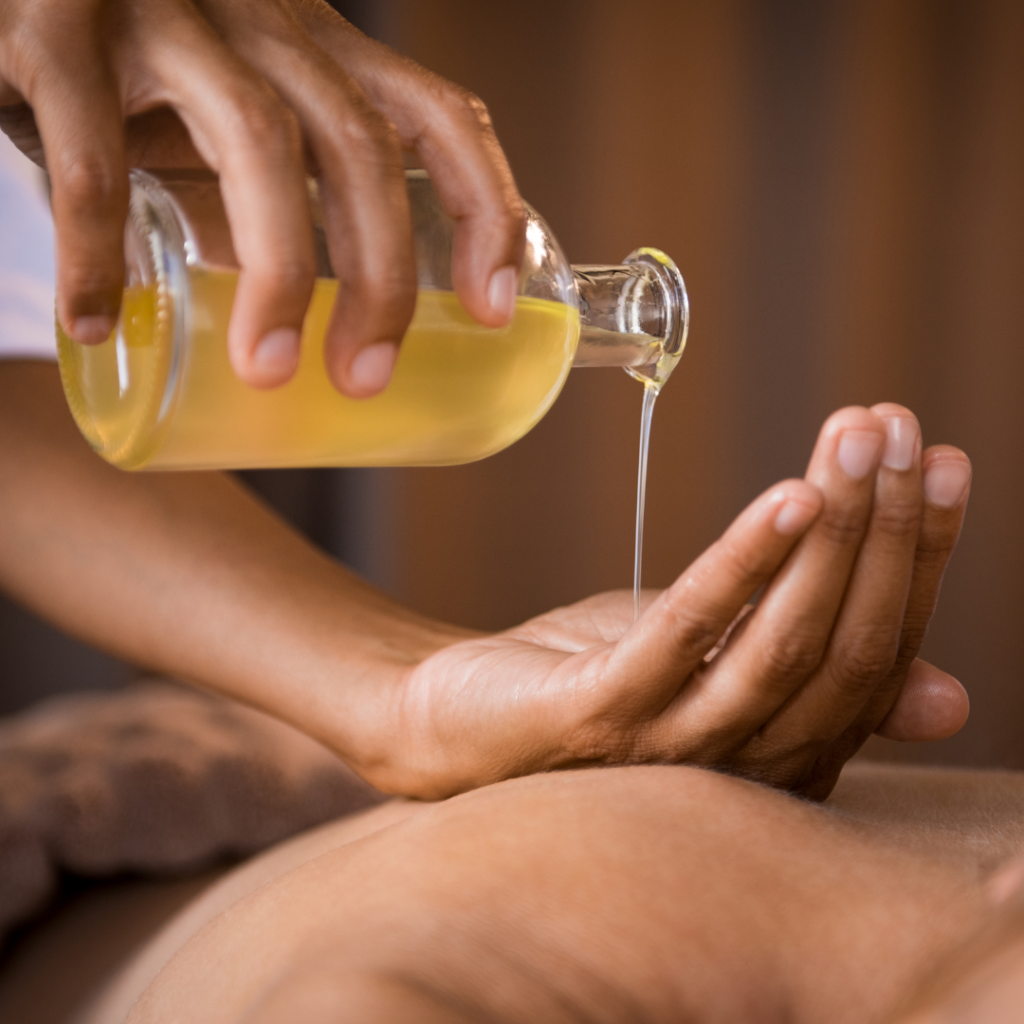 Therapist pouring massage oil at spa