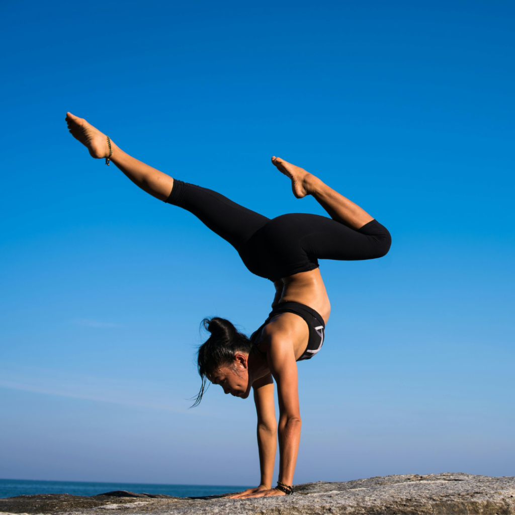 Woman With Arms Outstretched Against Blue Sky