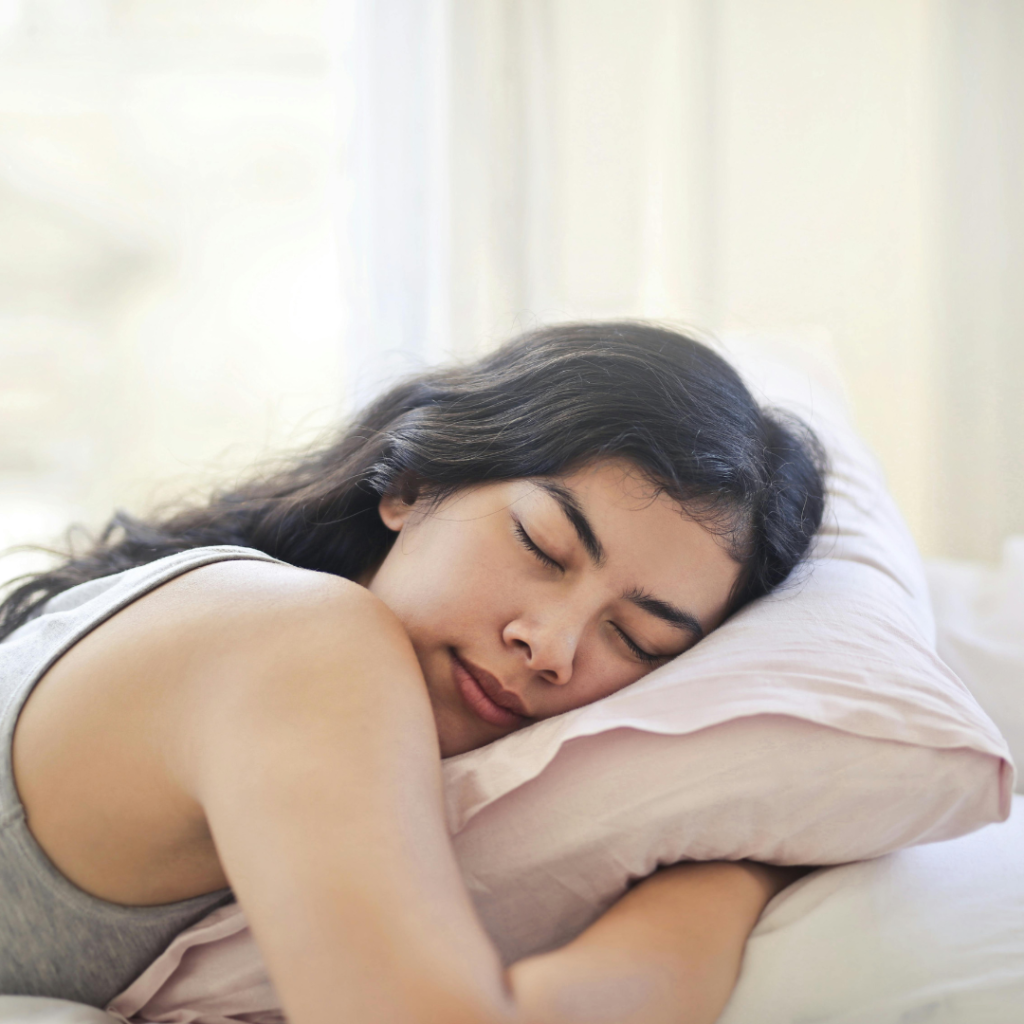 Woman in Gray Tank Top Lying on Bed