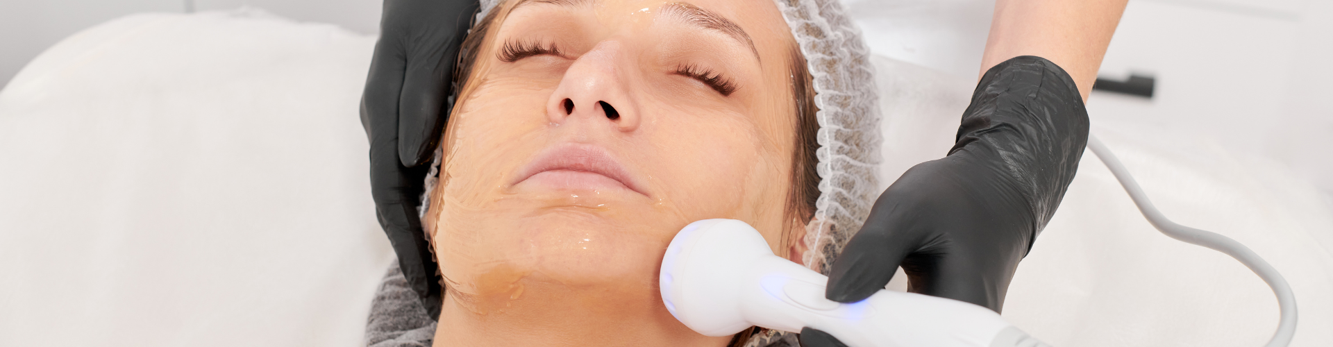 Beautician makes RF lifting for rejuvenation woman face, anti aging cosmetic procedure