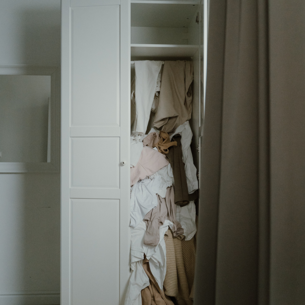 Photo of an Untidy and Messy White Wooden Closet