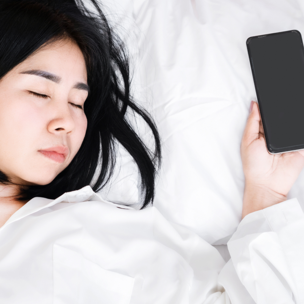 Nomophobia Concept with Asian Woman Sleeping with Hand Still holding mobile Phone,