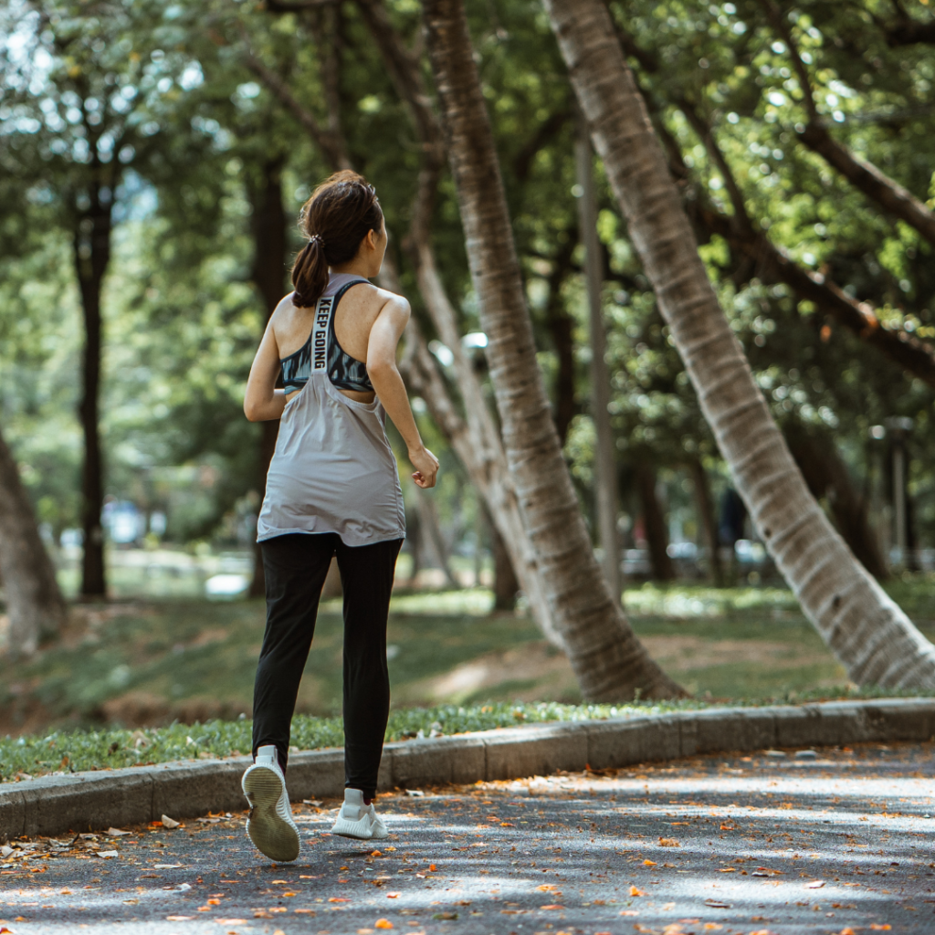 Active woman jogging in empty calm park