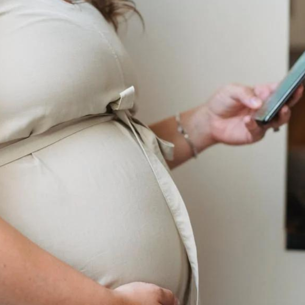 A Pregnant woman holding her baby bump