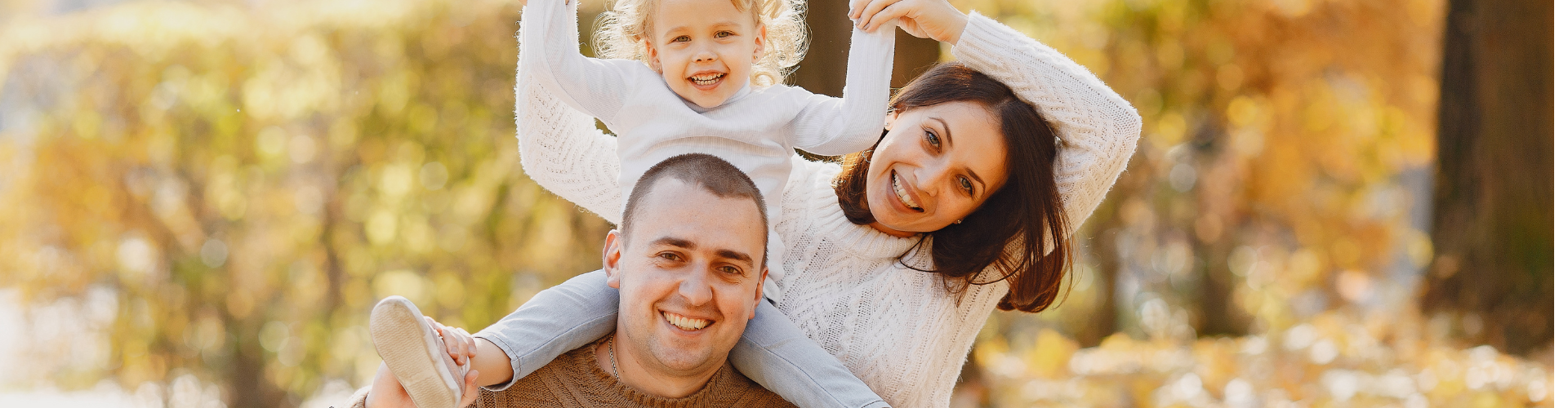 Cheerful family having fun in autumn park