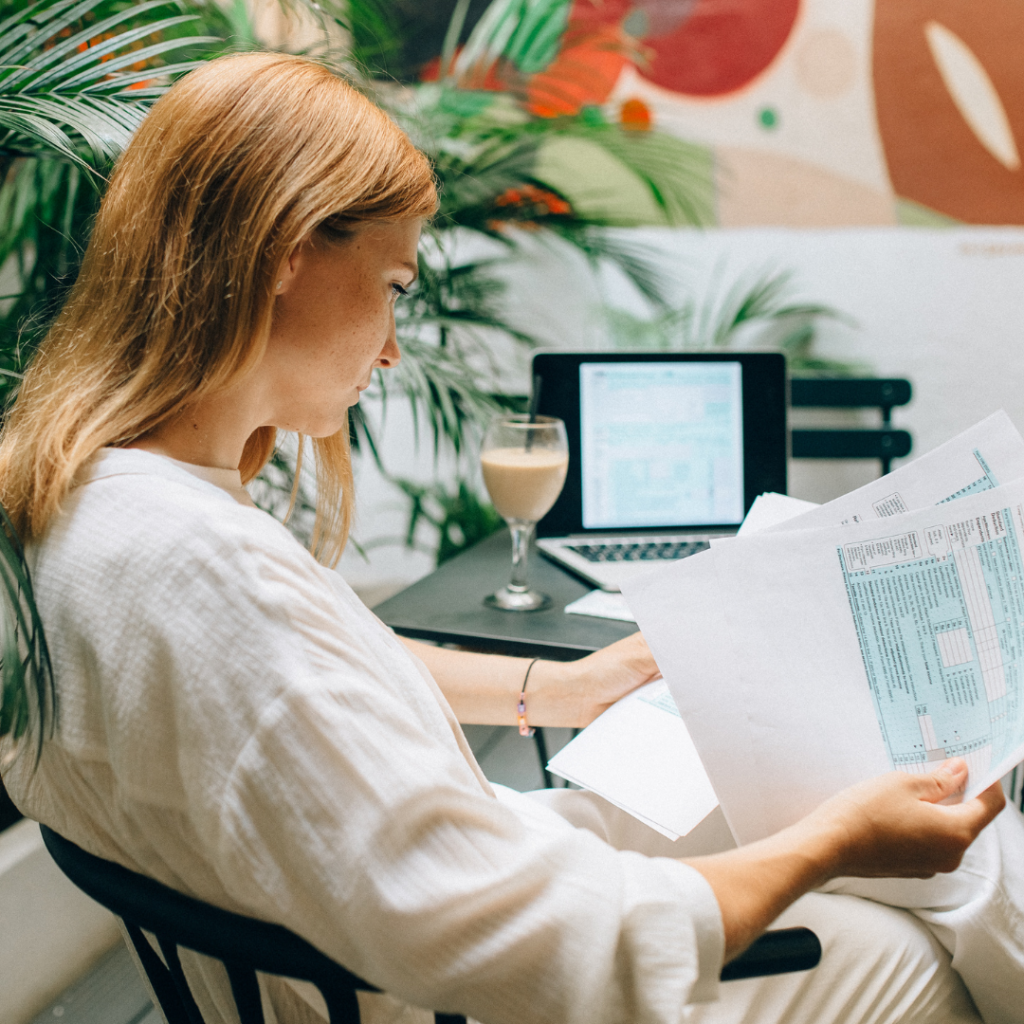 A Woman Reviewing Documents while Sitting