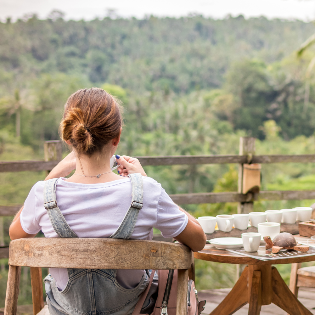 Brown-haired Woman Sitting on Brown Wooden Chair on Patio