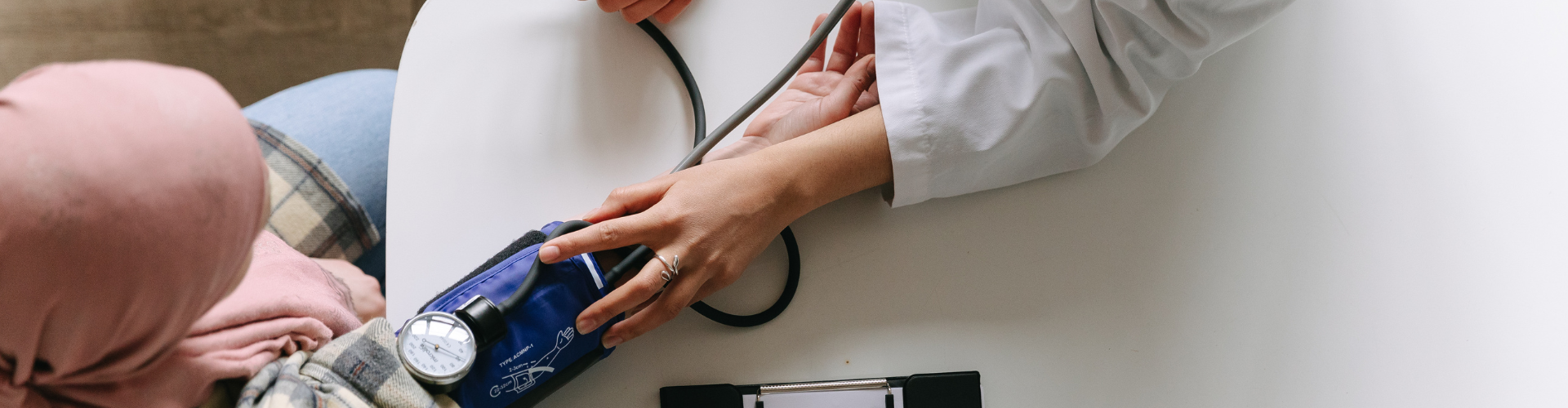 A Doctor Taking Patient's Blood Pressure