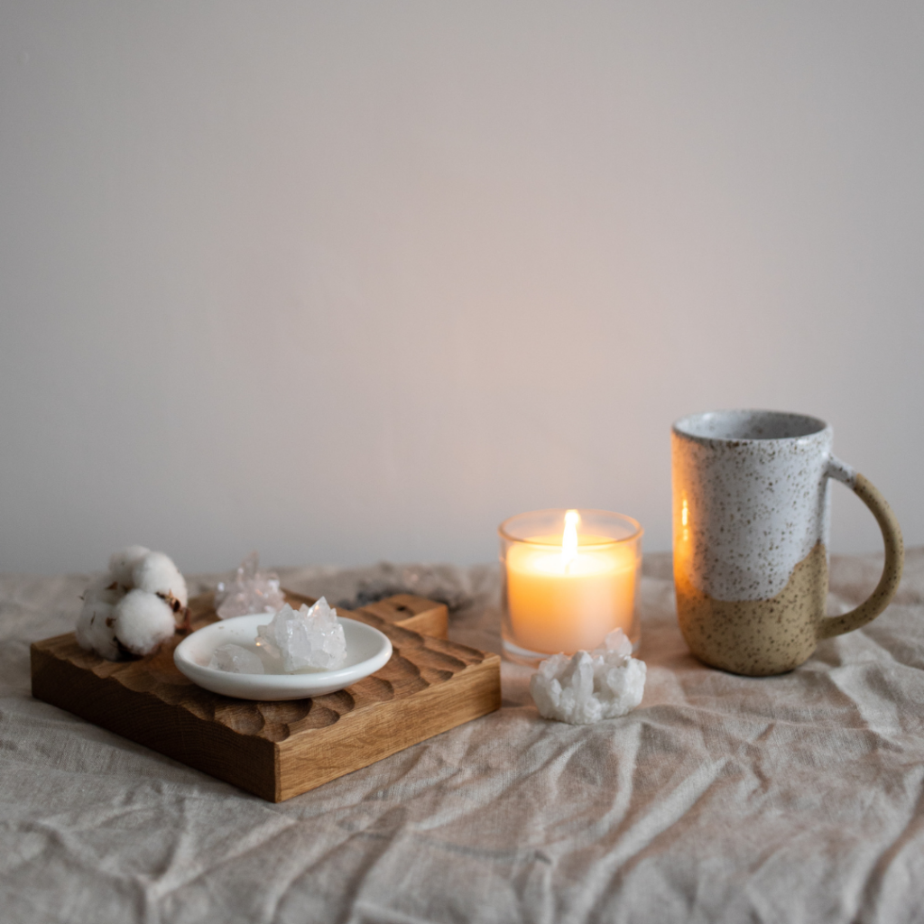 Mug Near Candle and Healing Crystals