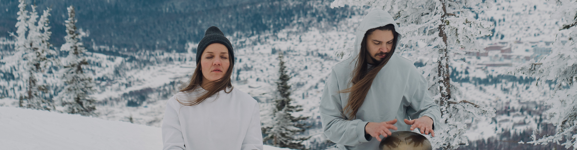 A Couple Meditating Outdoors in the Snow