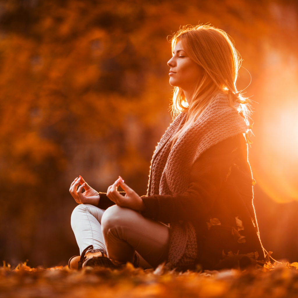 Woman meditating in autumn day.