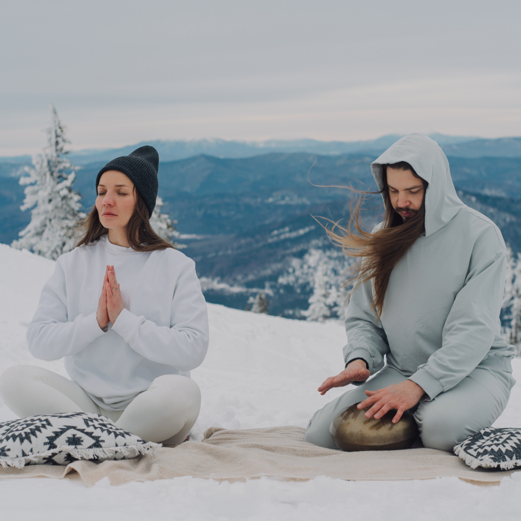 A Couple Meditating on a Snow Covered Ground