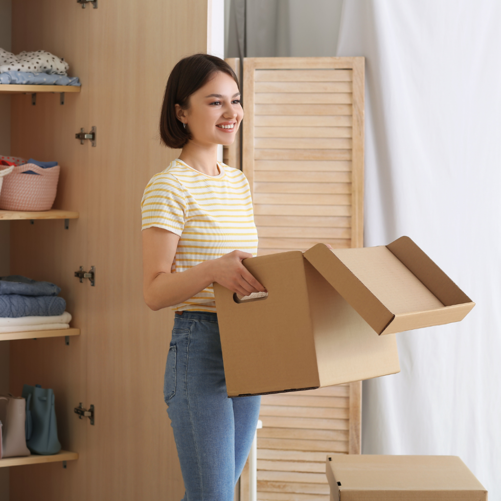 Young Woman Organizing Clothes at Wardrobe