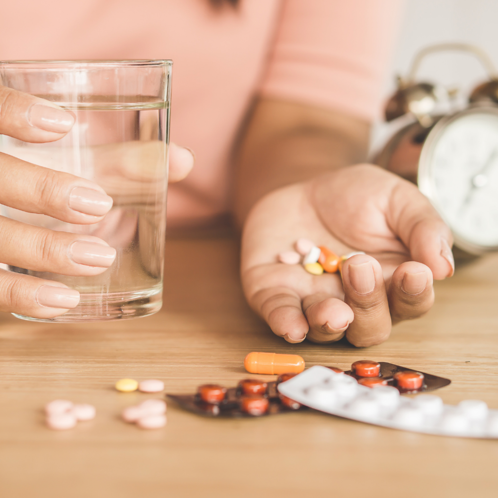 taking too much medication, chronic illness with woman hand taking many kinds of medicine