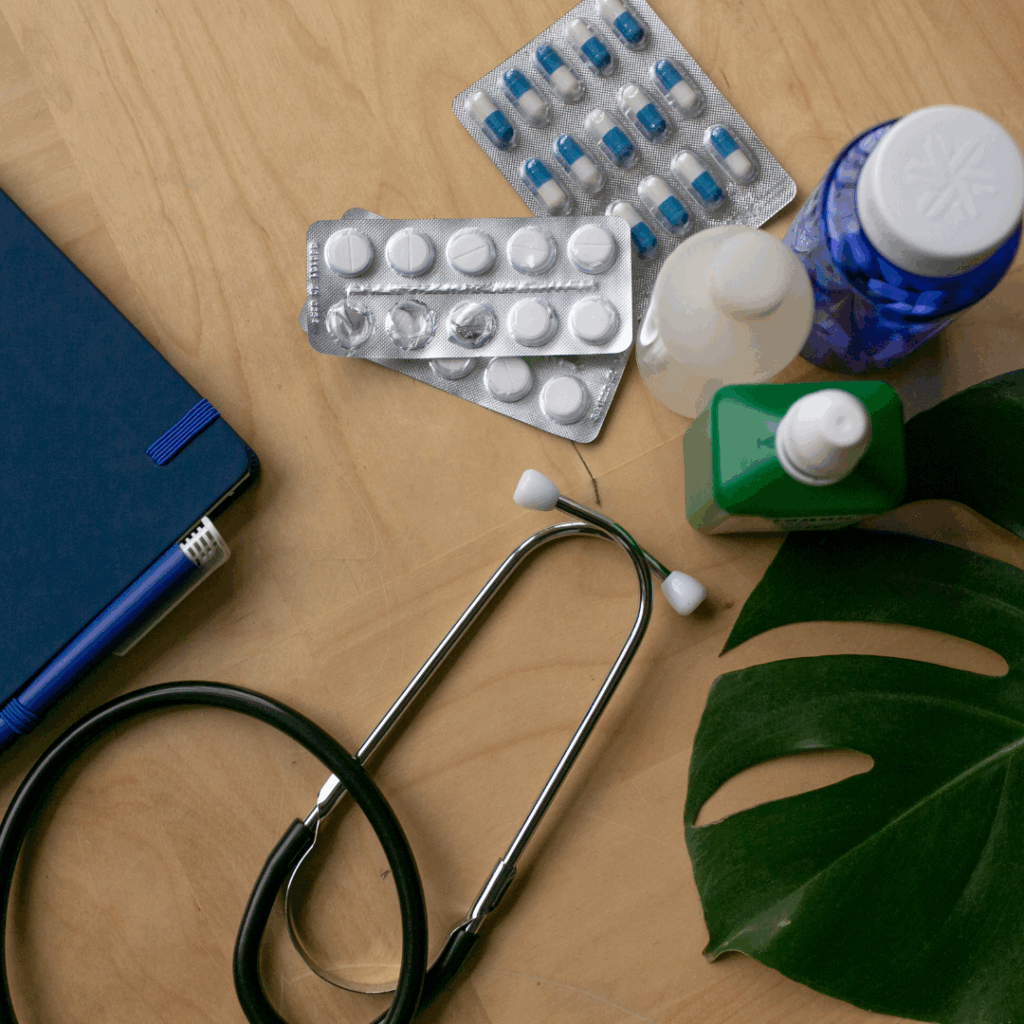 Green Medicine Flatlay of Medicines and Doctor's Equipment