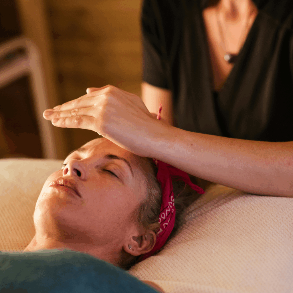 Crop masseuse performing reiki massage