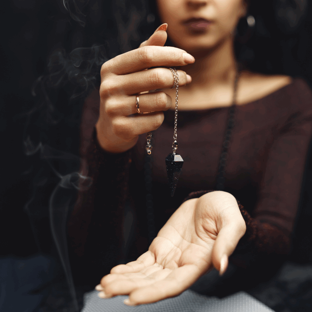 Hands of a Young Woman Holding a Necklace With a Gemstone