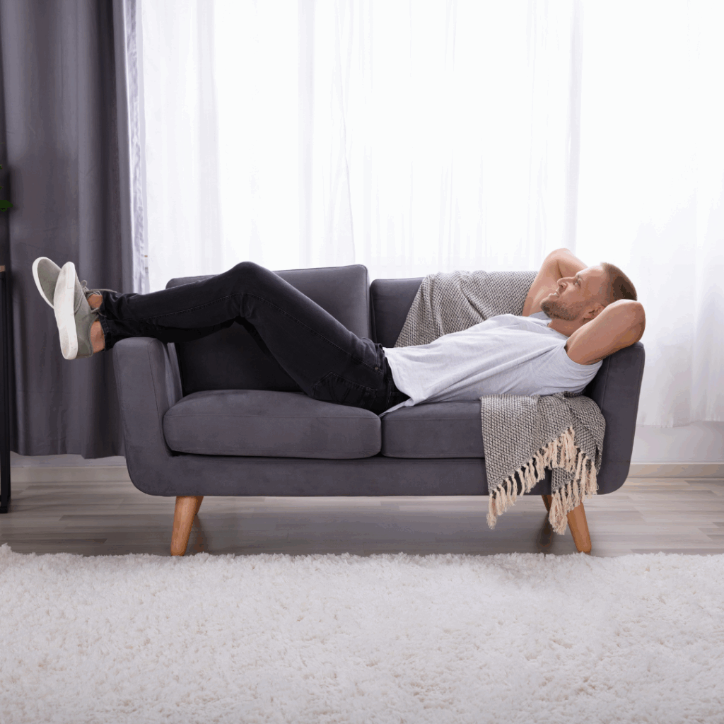 Man Relaxing On Sofa