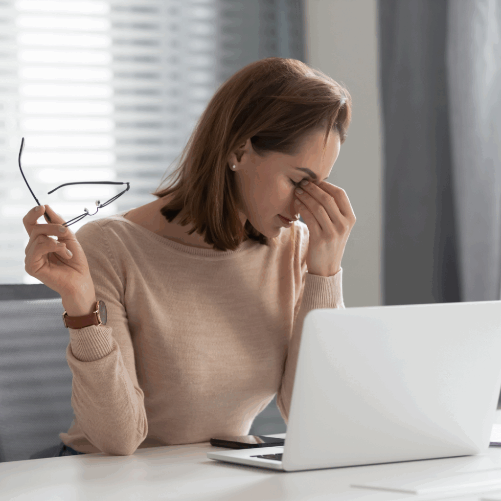 Fatigued stressed young businesswoman secretary feel eye strain at work