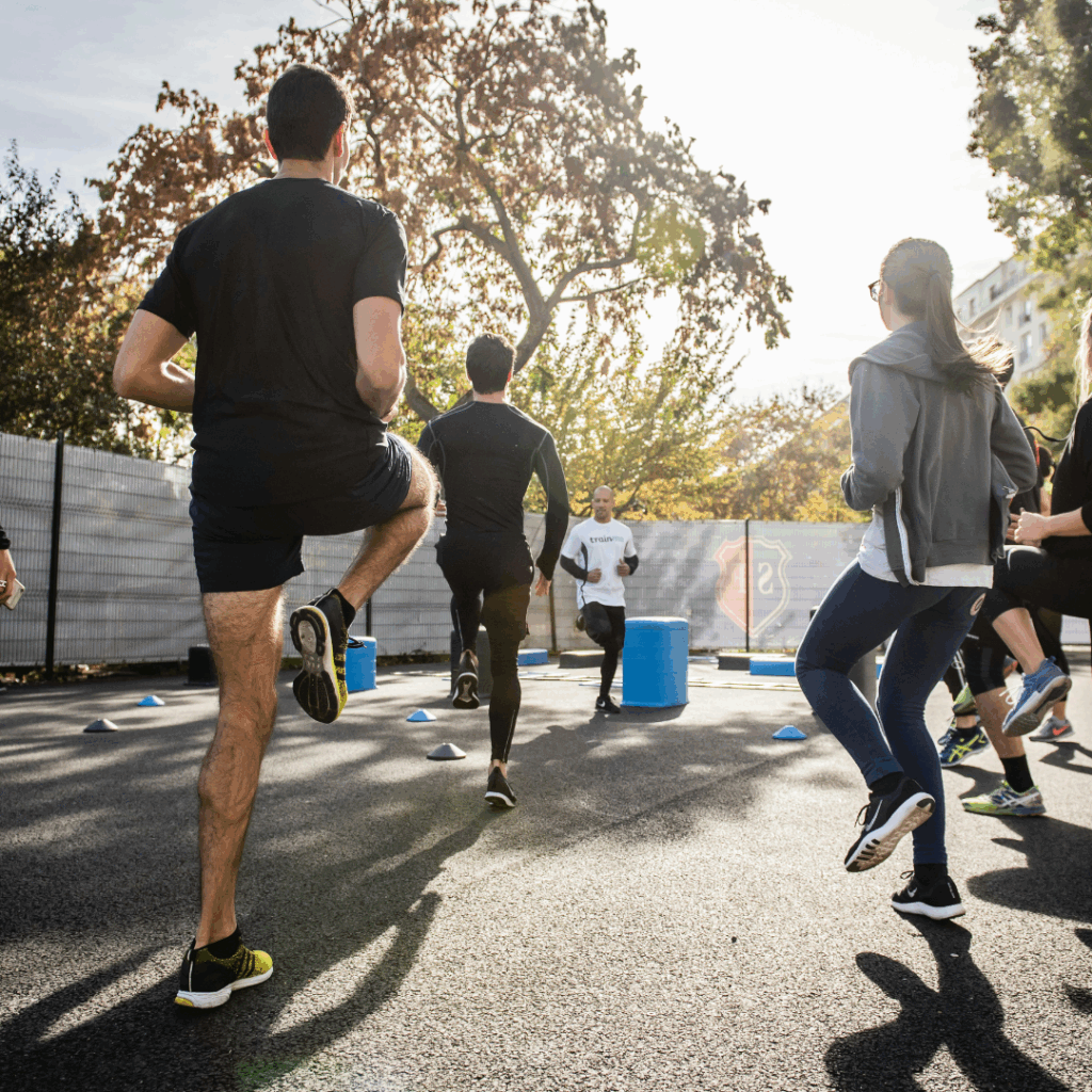 man in black t-shirt and black shorts running on road during daytime