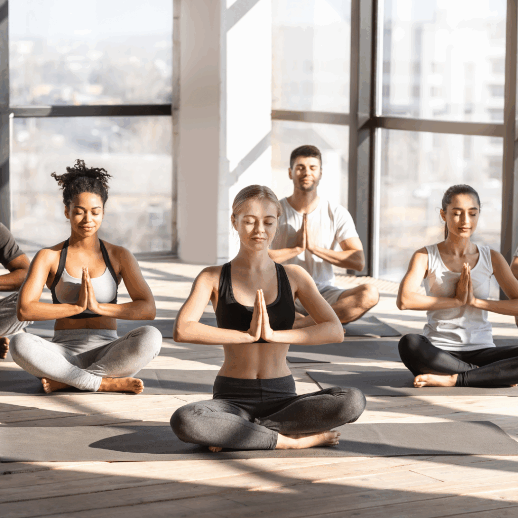 Yoga Session. Young multicultural people doing group meditation in modern studio