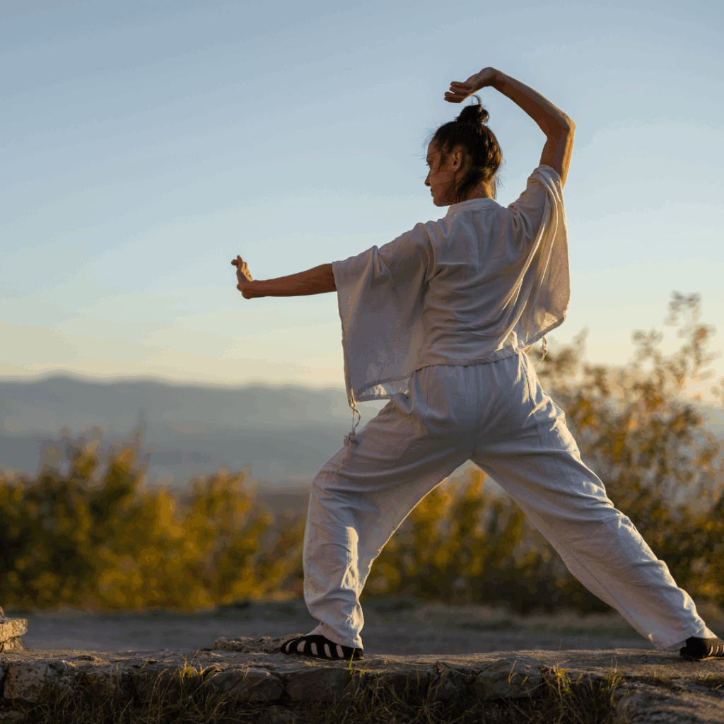 Woman doing tai chi outdoors
