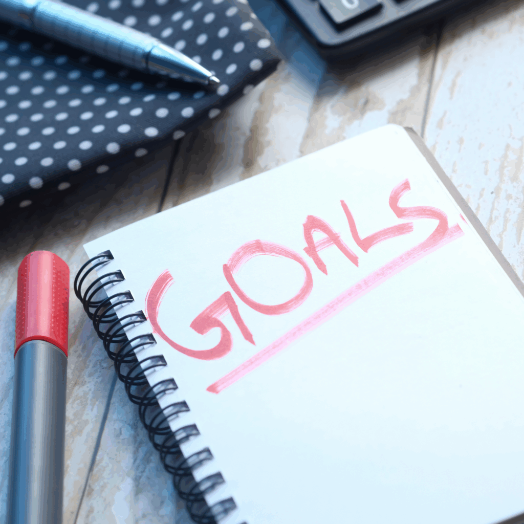 top view of new year goals text on notepad