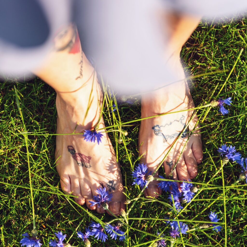 Woman's Bare Feet Standing on Grass