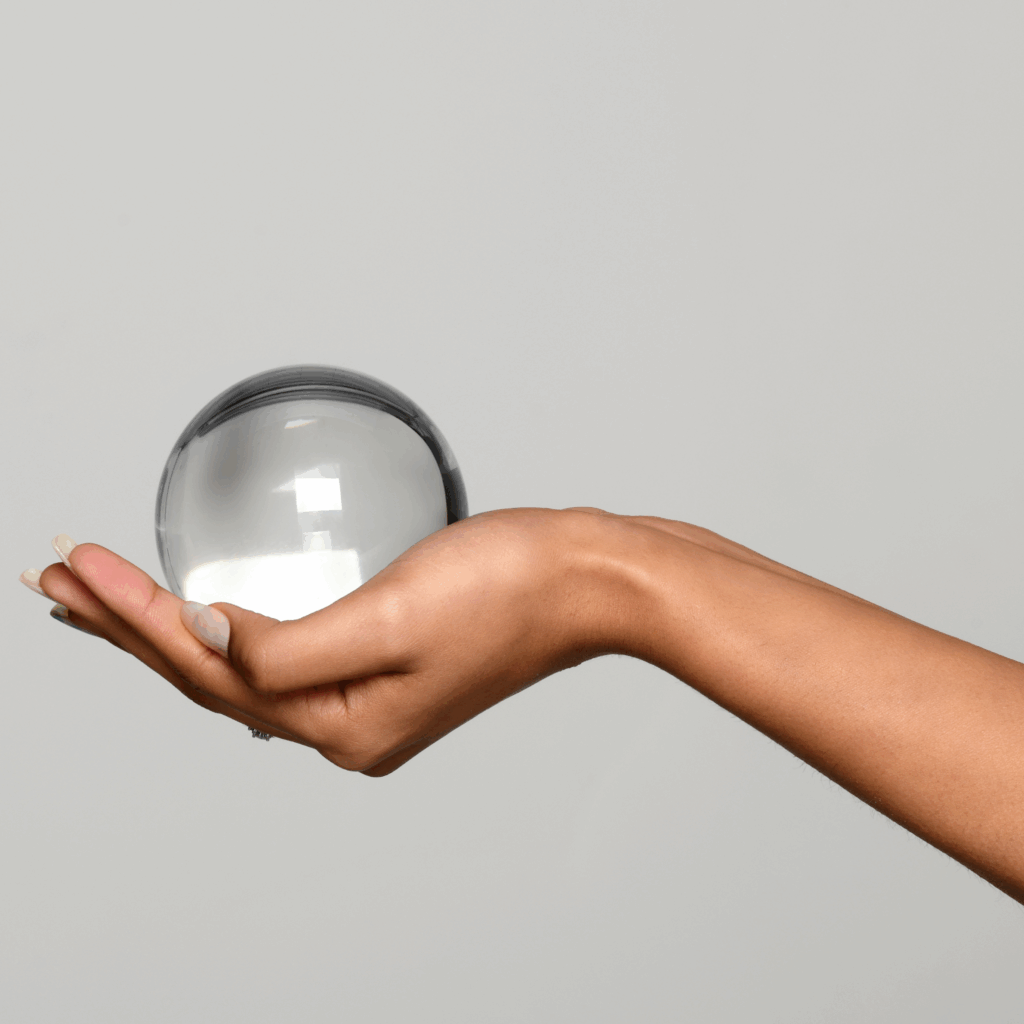 Hand Holding a Transparent Glass Sphere
