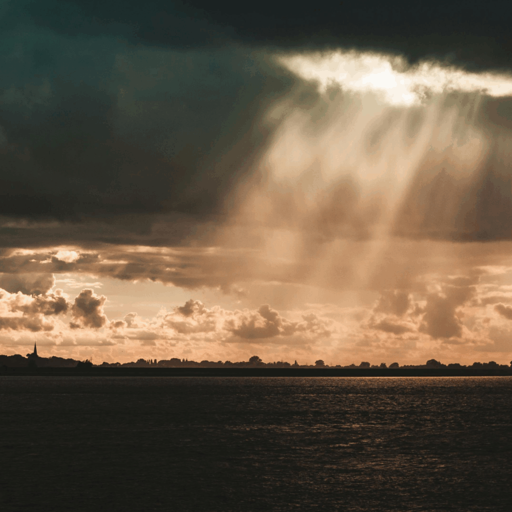 Dramatic Sun Rays Breaking Through Stormy Clouds